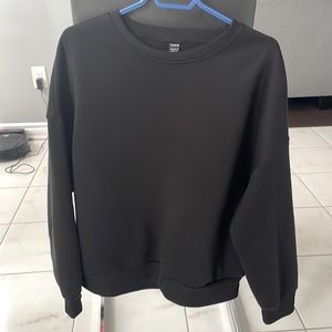 This is a black crewneck sweatshirt from shein size large US.